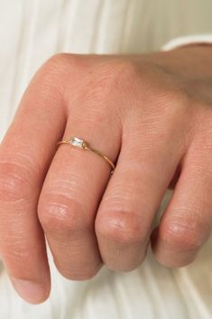 A simple ring that is perfect for a minimalist! Our dainty baguette ring is the sweetest little addition to our stacking ring collection. It features a tiny little cubic zirconia baguette in the middle. Stack it with your favorite rings, or wear it alone! Find more at Simple & Dainty! Elegant Tiny Rings For Everyday Wear, Elegant Tiny Rings For Everyday, Classic Baguette Rings For Everyday, Dainty Emerald Cut Rings For Everyday, Dainty Emerald-cut Rings For Everyday, Dainty Everyday Emerald-cut Rings, Emerald Cut Rings For Everyday Wear, Delicate Everyday Jewelry With Baguette Diamonds, Delicate Baguette Diamond Jewelry For Everyday