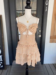 The Sheeba is an adjustable spaghetti strap gingham plaid ruffle tier mini dress with smocked waistband detailing and front cut out detailing. Model is wearing size Medium. Christmas Deals, Shoes With Jeans, Last Call, New Arrival Dress, Gingham, Spaghetti Strap, Spaghetti, Cut Out, Plaid