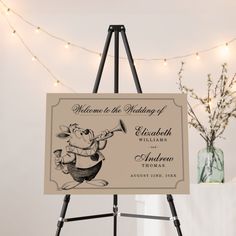 an easel with a sign on it that says welcome to the wedding of elizabeth and edward