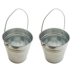 two metal buckets sitting next to each other on a white background with one empty