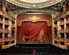 an ornately decorated stage with red curtains