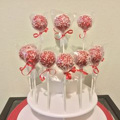 cake pops with red and white sprinkles on a plate