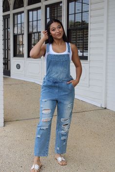 "Get ready to rock a cool, casual look with our Distressed Denim Overalls! The perfect mix of comfort and style, these overalls feature a loose fit and handy pocket for all your essentials. Say goodbye to boring outfits and hello to effortless cool. Denim never looked so good!" Casual Denim Jumpsuits And Rompers With Side Pockets, Casual Medium Wash Denim Jumpsuit With Side Pockets, Casual Dark Wash Denim Jumpsuit With Side Pockets, Everyday Dark Wash Overalls With Pockets, Casual Denim Jumpsuit With Side Pockets, Trendy Everyday Denim Jumpsuit With Pockets, Dark Wash Relaxed Fit Shortalls With Pockets, Relaxed Fit Dark Wash Shortalls With Pockets, Casual Denim Blue Jumpsuit With Frayed Hem