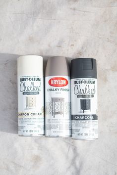 three cans of rustoleum and chalk paint sitting on a marble surface next to each other