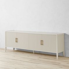 an empty room with a white cabinet and wood flooring on the wooden floor, in front of a white wall