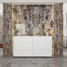 a white dresser sitting next to a wall covered in marble