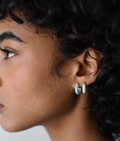 a close up of a person wearing some kind of earring on their left ear