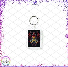 a keychain with an image of a spiderman on the front and purple sprinkles around it