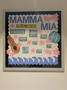 a bulletin board with the words mamma mia written on it and a ukulele