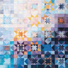 a quilt with many different colors and shapes