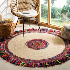 a round rug with multicolored fringes on the floor next to a chair