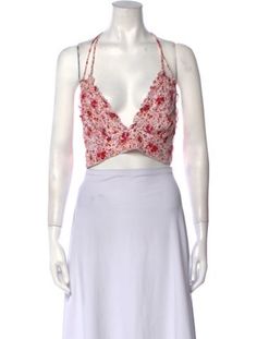 Poupette St Barth Crop TopWhitePrintedRuffle EmbellishmentSleeveless with V-NeckButton Closure at FrontFit:Tops by Poupette St Barth typically fit true to size. Feminine Sleeveless Floral Print Crop Top, Red V-neck Halter Top For Spring, White Fitted Feminine Halter Top, White Fitted V-neck Halter Top, White Low-cut Crop Top For Spring, Fitted White V-neck Halter Top, White Triangle Top Tank Top For Spring, White Triangle Top Tank For Spring, White Floral Print V-neck Tank Top