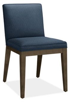 a blue upholstered chair with wooden legs