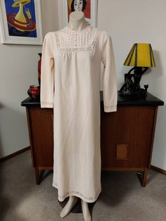 This nightgown would be ideal for a lady looking for a nightgown with sleeves, warmer fabric, higher neckline and a bit more demure and this would fit the bill. The gown has a high neck with a pretty feature on the yoke, a single button at the back to close, long sleeves and long length. Measurements are Shoulder to shoulder 38cm Bust 98cm Sleeves shoulder to cuff 56cm Length shoulder to hem 31cm Beige Long Sleeve Sleepwear, Long Sleeve White Nightgown For Sleep, White Long Sleeve Nightgown For Sleep, Cream Long Sleeve Sleepwear For Sleepover, Cream Long Sleeve Sleepwear For Home, Cream Long Sleeve Daywear Dress, Cream Long Sleeve Sleepwear, Long Sleeve Lace Trim Sleepwear For Bedtime, White Long Sleeve Nightgown For Daywear