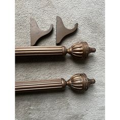 two old fashioned metal handles on top of a white carpet