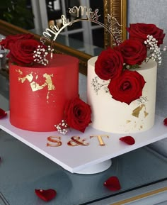 two red and white cakes sitting on top of a table