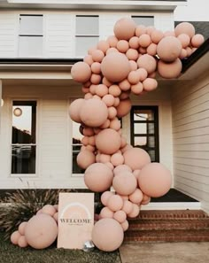 a large balloon arch in front of a house