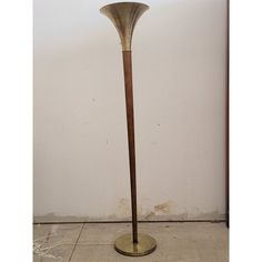 a floor lamp that is standing on the ground