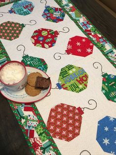 a table topped with a plate of food next to a cup of coffee and cookies