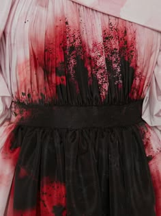 a dress with red and black paint splattered on it