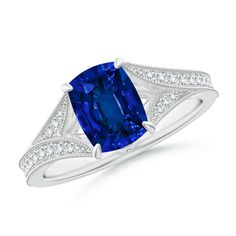 a blue sapphire and diamond ring with white diamonds on the sides, set in 18k white gold