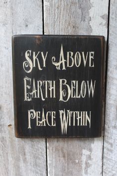 a sign that says sky above earth below peace within