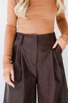 No matter the celebration, the Exceptional Vision Brown Leather Culotte Pants will enhance your beautiful glow! Crafted with meticulous attention to detail, these culottes redefine contemporary fashion with a touch of timeless elegance. The rich brown leather exudes a warm and luxurious feel, creating a versatile piece that effortlessly transitions from day to night. The culotte silhouette adds a modern twist to the classic leather pants, offering a relaxed yet tailored fit. The wide-leg design Elegant Short Bottoms For Date Night, Brown Culottes Outfit, Elegant Shorts For Night Out In Fall, Chic Bottoms With Built-in Shorts For Fall, Chic High Waist Formal Shorts, Elegant Short Length Bottoms For Date Night, Chic Brown Short Bottoms, Short Length Bottoms For Date Night In Fall, Short-length Bottoms For Date Night And Fall