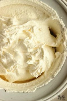 a white bowl filled with whipped cream on top of a table