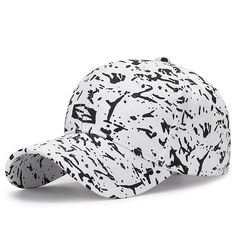 a white baseball cap with black paint splattered on it