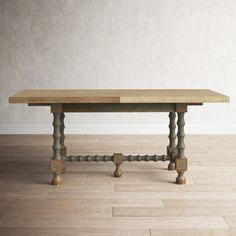 an old wooden table with two legs on the floor in front of a white wall