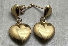 Beautiful vintage double heart earrings, 14 kt gold with gold posts.  14 kt is stamped on the posts and also on the earring backs.  Weight 1.66 grams.  Width 12 mm and length 25 mm.   This item is preloved and Antique/Vintage. This means it may have signs of wear and use and is offered as is.  You will receive the exact item shown in the photos. There may be slight color variation depending on your monitor display. Please see pictures as they are part of the item description. Please contact me if you want more information and/or pictures for this item. All gems are tested with the Presidium Gem Tester II. And all metals are tested for purity verification using the demonstrated testing system. ALL SIZES ARE LISTED IN DESCRIPTION, BUYER WILL BE LIABLE FOR RESTOCKING FEE IF ITEM IS SENT BACK Flagstaff Az, All Gems, Double Heart, Heart Studs, Etsy Earrings Dangle, Earring Backs, Heart Earrings, Antique Vintage, Jewelry Earrings Dangle