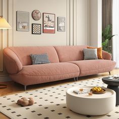 a living room with pink couches and pictures on the wall above it, along with a coffee table