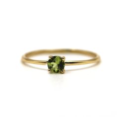 The August Birthstone is Peridot. The ring is 14k yellow-solid gold with the natural birthstone "Peridot".  It looks very delicate and timeless styles by New York Jewelry Designer. The gemologist professional carefully takes care of the gemstone, and the setter has very high-quality skills to make the birthstone ring. Yes! It's a great choice to get birthday gifts.  For more, please see the below about the Peridot birthstone gold ring,   14k Yellow Gold 100% natural Peridot (Size: 4mm/Color: Yellowish-Green) Associated month: August Birthstone Zodiac Sign: Leo and Virgo share the Peridot stone.  Meanings: Healing Properties and Benefits Color: Green, Yellow High-Polished Finish. All of our jewelry is handmade in our studio in the U. S." Gift wrapping available. How to Cleanse Peridot: Keep Gemstone Gold Ring, New York Jewelry, Peridot Birthstone, Peridot Stone, August Birthstone, Peridot Gemstone, White Gold Band, August Birth Stone, Yellow Gold Ring