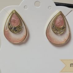 two pairs of pink and gold earrings on a white display stand with the tag attached