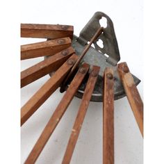 a metal and wood object with several wooden sticks sticking out of it's center