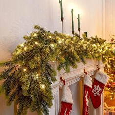 stockings hung on the mantle with christmas lights