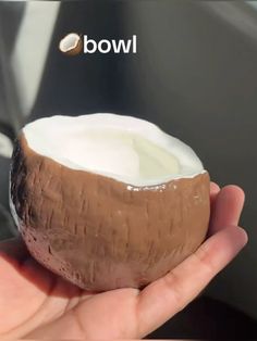 a person holding a half eaten coconut in their hand with the word wow above it