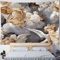 a large wall hanging over a bed with an angel and flowers tapestry on the wall