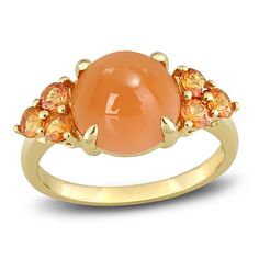 A mesmerizing round natural orange moonstone cabochon is flanked by trios of incredible natural orange sapphire in this impressive women's ring, fashioned in 14K yellow gold. Orange Multi-stone Fine Jewelry Rings, Orange Sapphire Round Ring, Orange Multi-stone Round Rings, Round Orange Moonstone Ring, Orange Moonstone Gemstone Ring, Orange Moonstone Ring, Luxury Orange Topaz Round Ring, Luxury Orange Topaz Ring, Luxury Orange Round Topaz Ring