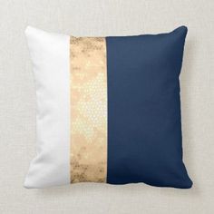 an elegant gold and navy blue pillow with white trim on it's side, along with the same color scheme