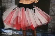 a mannequin wearing a red and white tutu skirt with black trims