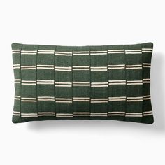 a green pillow with white stripes on it