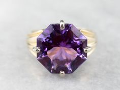 Outstanding! This solitaire cocktail ring is all about the gemstone. One, simple, solitary gem, set up in the modernist style. The clean geometric lines of this fancy cut allow this wonderful amethyst to sparkle with undertones of regal purple and raspberry, we've set this stone into a simple two-tone gold mounting creating a sophisticated statement piece! Metal: 14K Yellow and White Gold  Gem: Amethyst 4.20 Carats  Gem Measurements: 13.0 mm, Octagon Ring Size: 6.50 Marks: "IJS14K" Stamped on the inside band Octagon Ring, Amethyst Cocktail Ring, Gold Amethyst Ring, Purple Band, Birthstone Gifts, Geometric Lines, February Birth Stone, Metal Pendant, Amethyst Ring