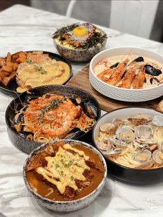 a table topped with bowls filled with different types of food