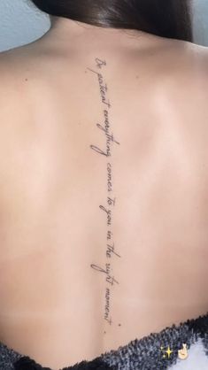 the back of a woman's neck with writing on it