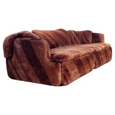 a brown striped couch sitting on top of a white floor