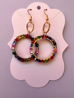 Introducing our Vibrant Glass Bead Circle Earrings, a lively burst of color and sparkle perfect for any occasion! These unique earrings are handmade with precision, using an array of colorful glass beads arranged in a stunning circle design. Please note that each of our items is handmade with love and care. As such, the product you receive may not look exactly like the picture. Minor variations in color, shape, and size are to be expected and add to the unique, one-of-a-kind nature of each piece Rainbow Glass, Circle Design, Circle Earrings, Handmade With Love, Unique Earrings, Glass Bead, Colored Glass, Jewelry Earrings Dangle, Etsy Earrings