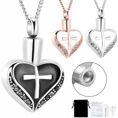 two heart shaped pendants with cross and diamond accents on the front, one is black and