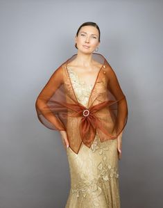 A very elegant organza shawl for your wedding party or evening dress. The rhinestone buckle is included. Made of light organza, slightly sparkles on the sun or light. Color: burnt orange  (other colors are available) Size: 170 cm x 48 cm approx.  You can use it as a wrap, shawl or stola. WE have matching bags in our Etsy Shop! WE accept credit cards! Organza Shawl, Orange Wedding, Wrap Shawl, Shawls And Wraps, Other Colors, Burnt Orange, Womens Scarves, Credit Cards, Evening Dress