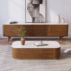 a living room with a coffee table and art on the wall